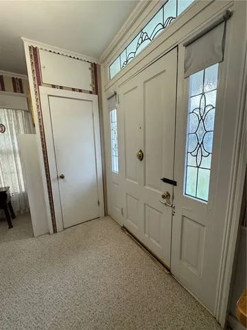a view of a hallway and a livingroom with furniture