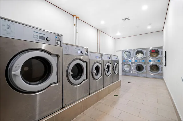 a view of a storage & utility room with dryer and washer