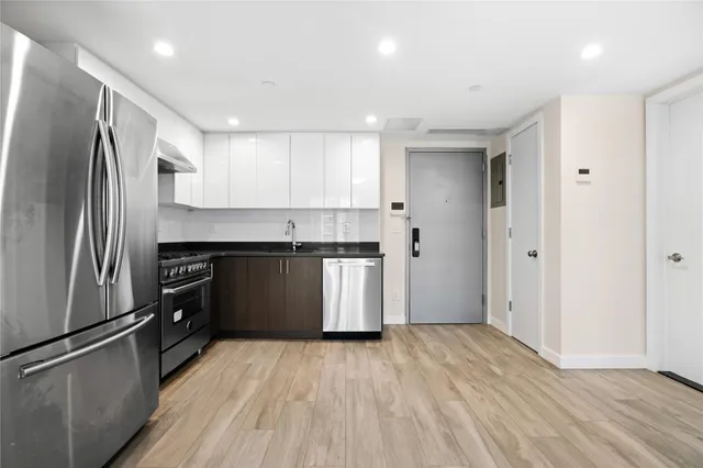 a kitchen with a refrigerator and a sink