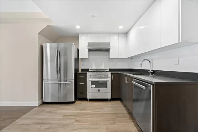 a kitchen with a refrigerator and a sink