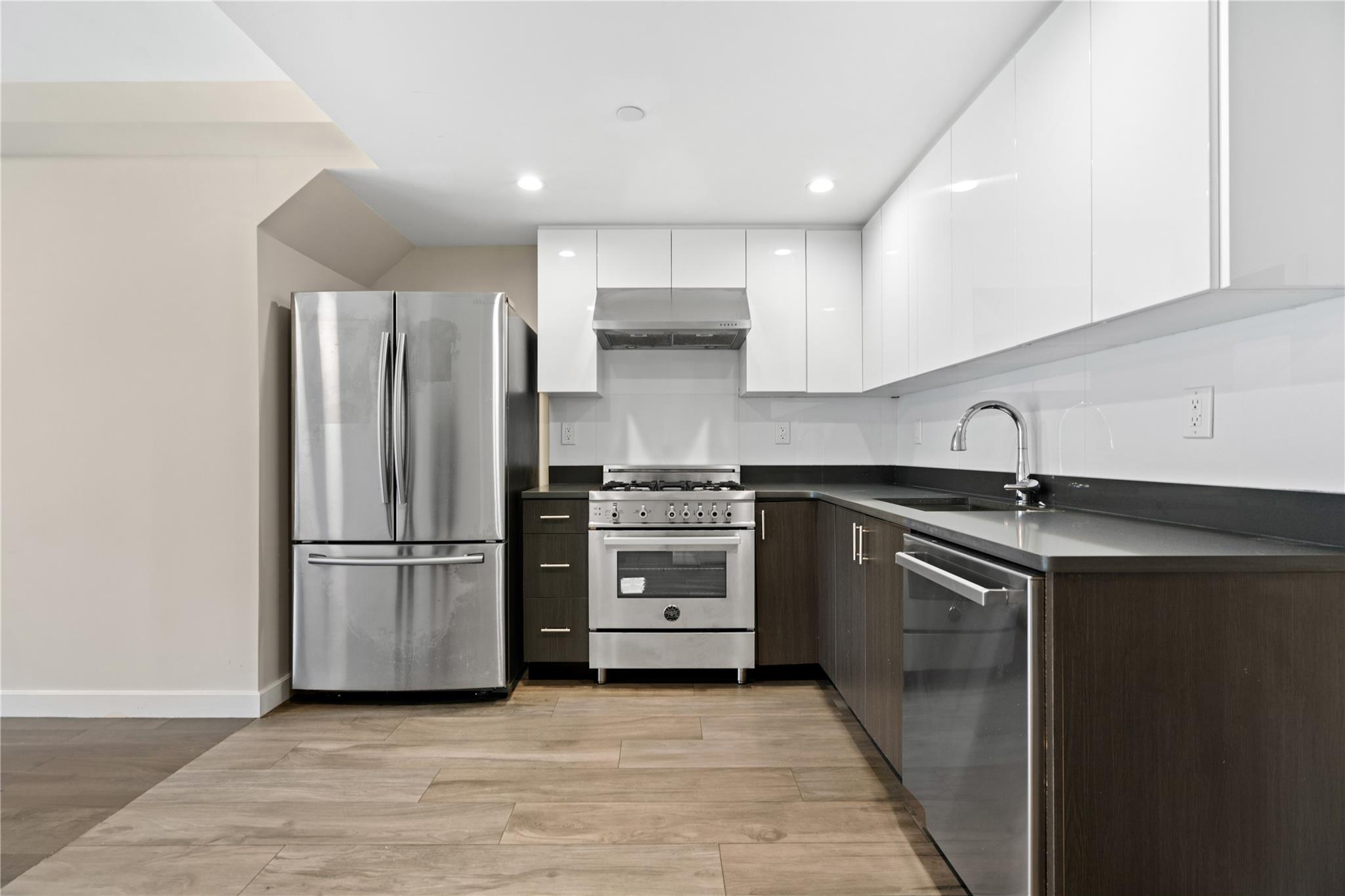 9745 63rd Drive, Unit 7A Queens, NY 11374 - Photo 7 of 20 a kitchen with a refrigerator and a sink