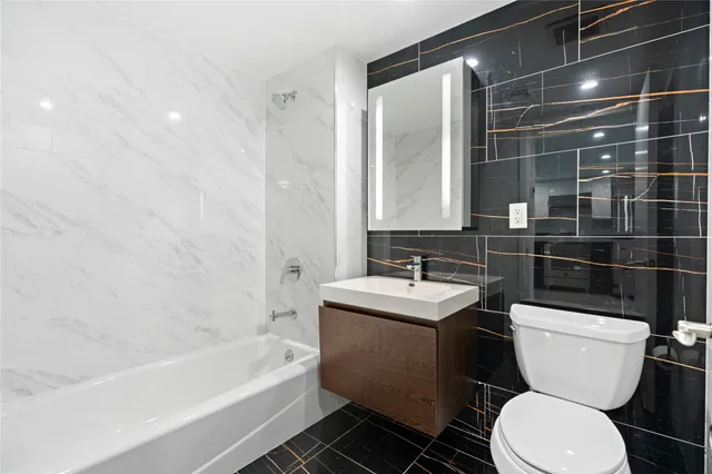 a bathroom with a toilet a sink and bathtub