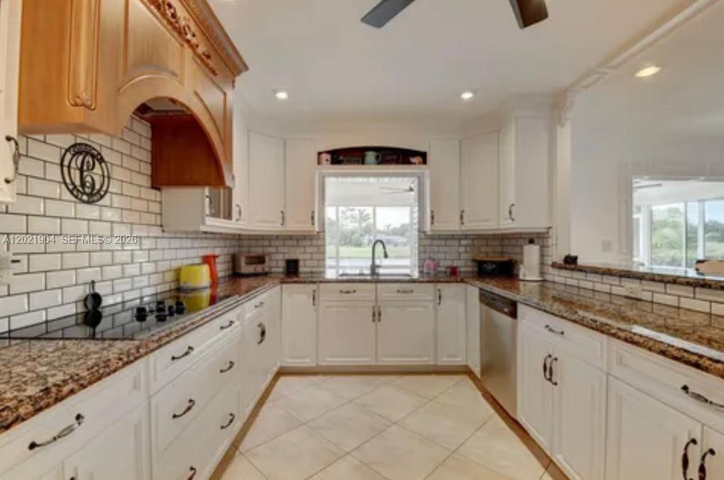 3324 Lakeview Boulevard Delray Beach, FL 33445 - Photo 11 of 36 a kitchen with white cabinets and appliances