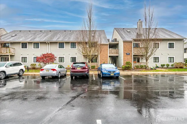 a view of a cars park in front of a building