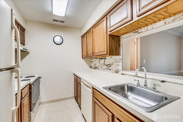 a kitchen with a sink and a refrigerator