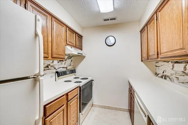 a view of a kitchen with sink washer and dryer