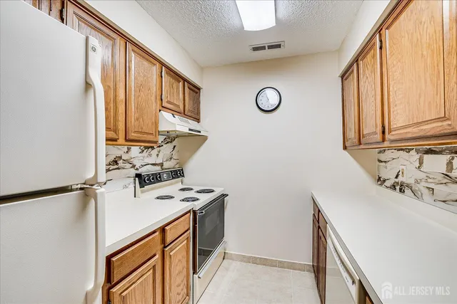 a view of a kitchen with sink washer and dryer
