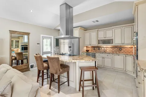 a bedroom with a bed a flat screen tv and a large window