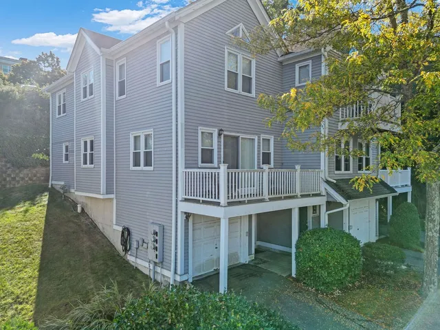 a view of a house with backyard and trees