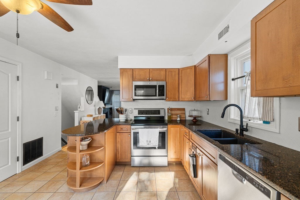 1810 Highland Avenue, Unit 22 Fall River, MA 02720 - Photo 13 of 33 a kitchen with stainless steel appliances granite countertop a sink and a stove