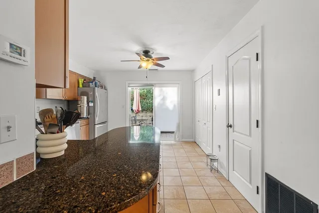 a view of a hallway with dining area and chandelier