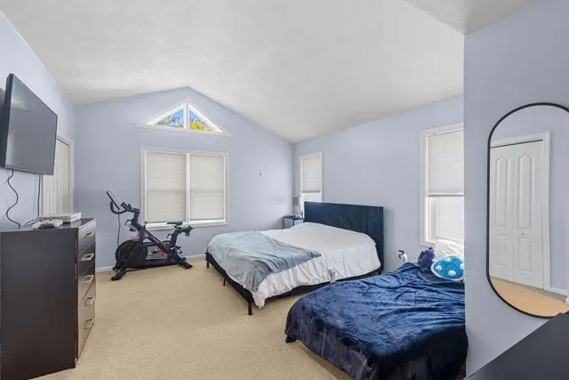 a bedroom with two beds and a window