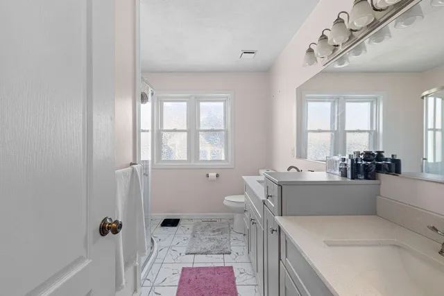 a bathroom with a tub sink and mirror