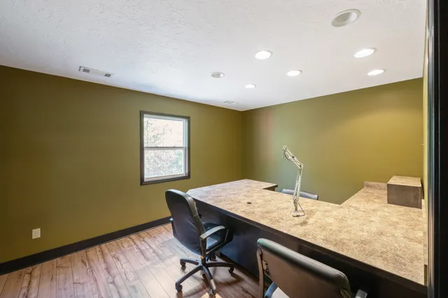 a living room with kitchen island granite countertop furniture and a large window