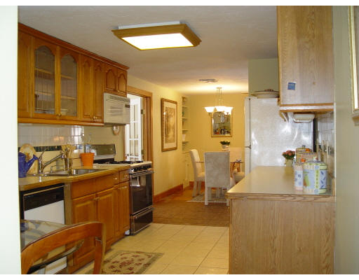 662 Stow Road Boxborough, MA 01719 - Photo 4 of 5 a kitchen with stainless steel appliances granite countertop a sink stove and refrigerator