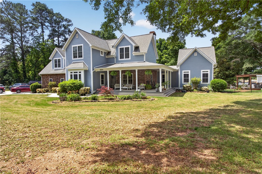 1504 Double Springs Road Townville, SC 29689 - Photo 21 of 41 This inviting residence features a spacious front yard, a charming porch, and a well-maintained lawn.