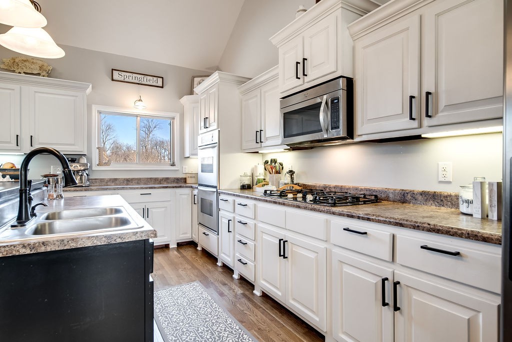 4945 Charles Dorris Road Springfield, TN 37172 - Photo 15 of 41 a kitchen with granite countertop white cabinets and stainless steel appliances