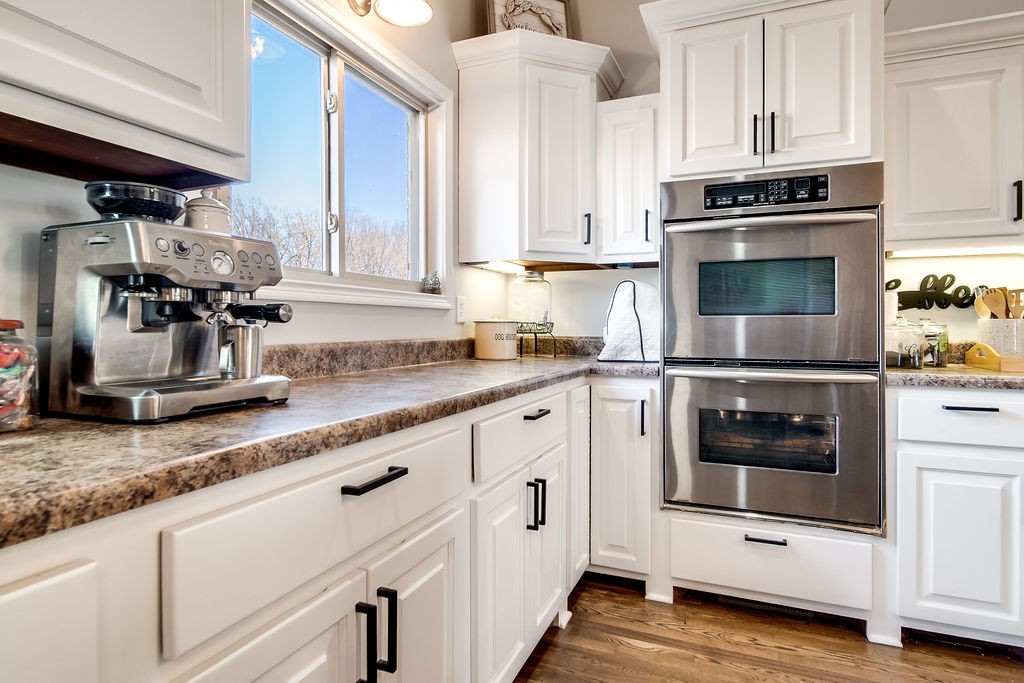 4945 Charles Dorris Road Springfield, TN 37172 - Photo 17 of 41 a kitchen with granite countertop white cabinets and white appliances