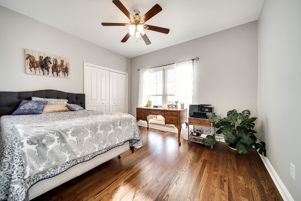 4945 Charles Dorris Road Springfield, TN 37172 - Photo 20 of 41 a bedroom with a bed and a chandelier