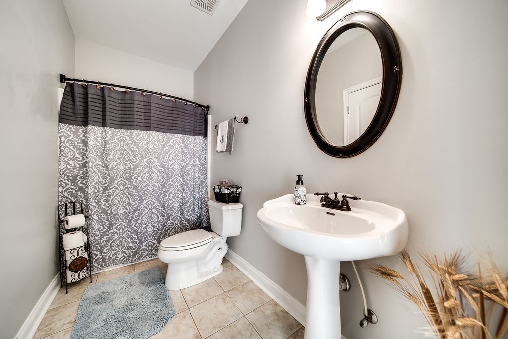 4945 Charles Dorris Road Springfield, TN 37172 - Photo 22 of 41 a bathroom with a sink toilet and a mirror
