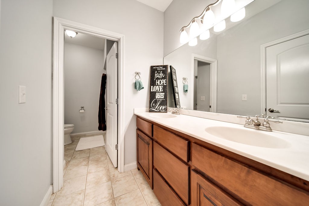 4945 Charles Dorris Road Springfield, TN 37172 - Photo 33 of 41 a spacious bathroom with a double vanity sink and a mirror
