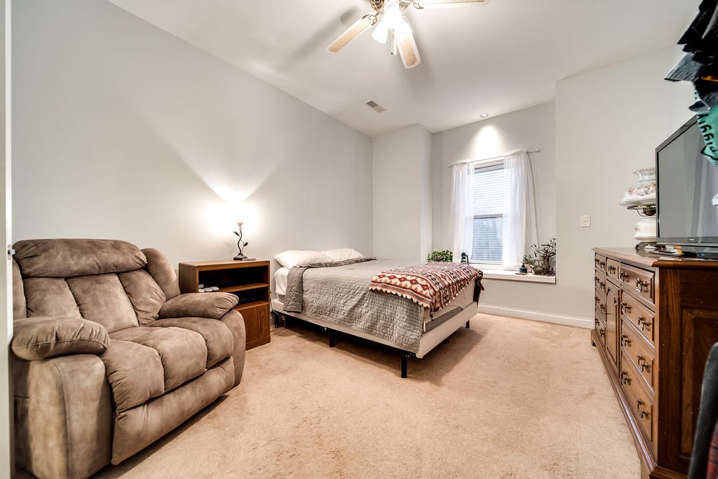 4945 Charles Dorris Road Springfield, TN 37172 - Photo 35 of 41 a bedroom with a bed couch and a fireplace