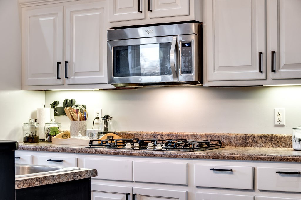4945 Charles Dorris Road Springfield, TN 37172 - Photo 39 of 41 a kitchen with granite countertop white cabinets and stainless steel appliances