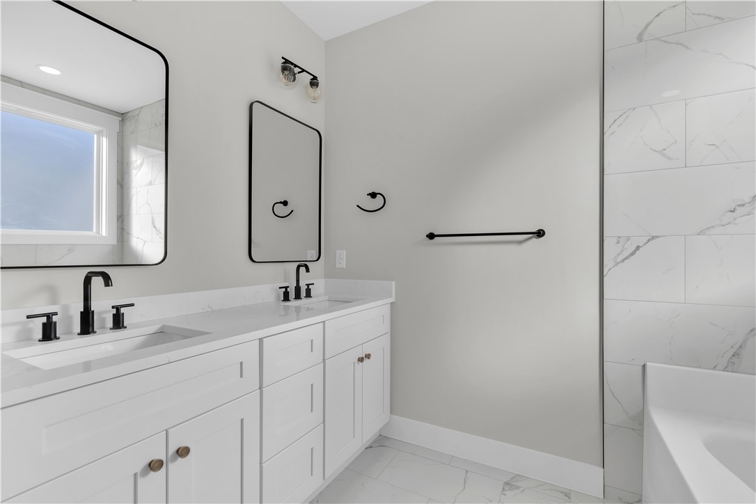 516 Lakeside Drive Anderson, SC 29621 - Photo 25 of 32 Dual vanities with sleek black fixtures enhance this well-appointed bathroom's functionality.