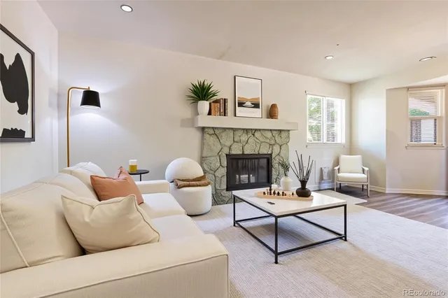 a living room with furniture and a fireplace