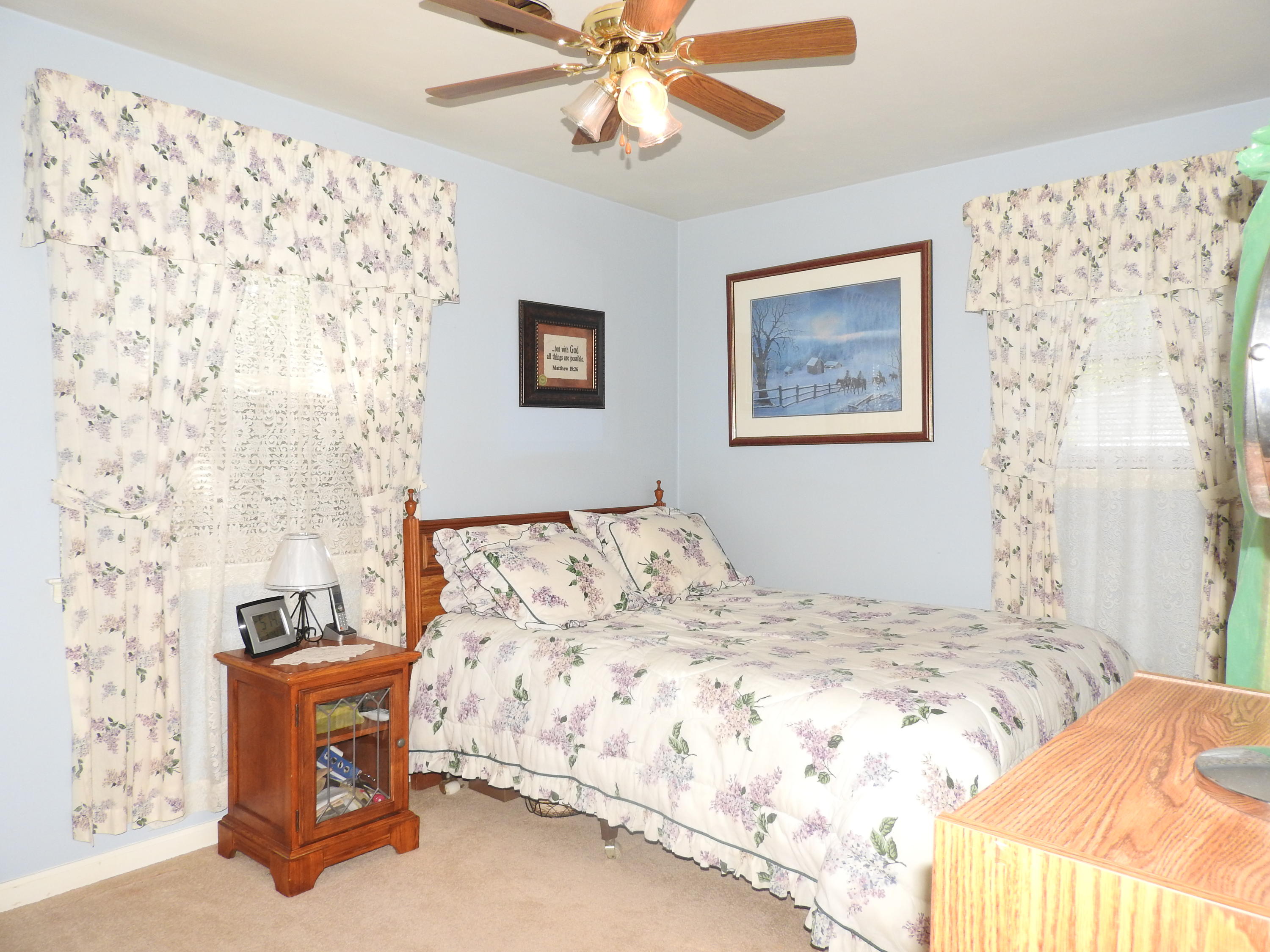2370 Morgans Mill Road Goodview, VA 24095 - Photo 14 of 24 a bedroom with a bed and a chandelier
