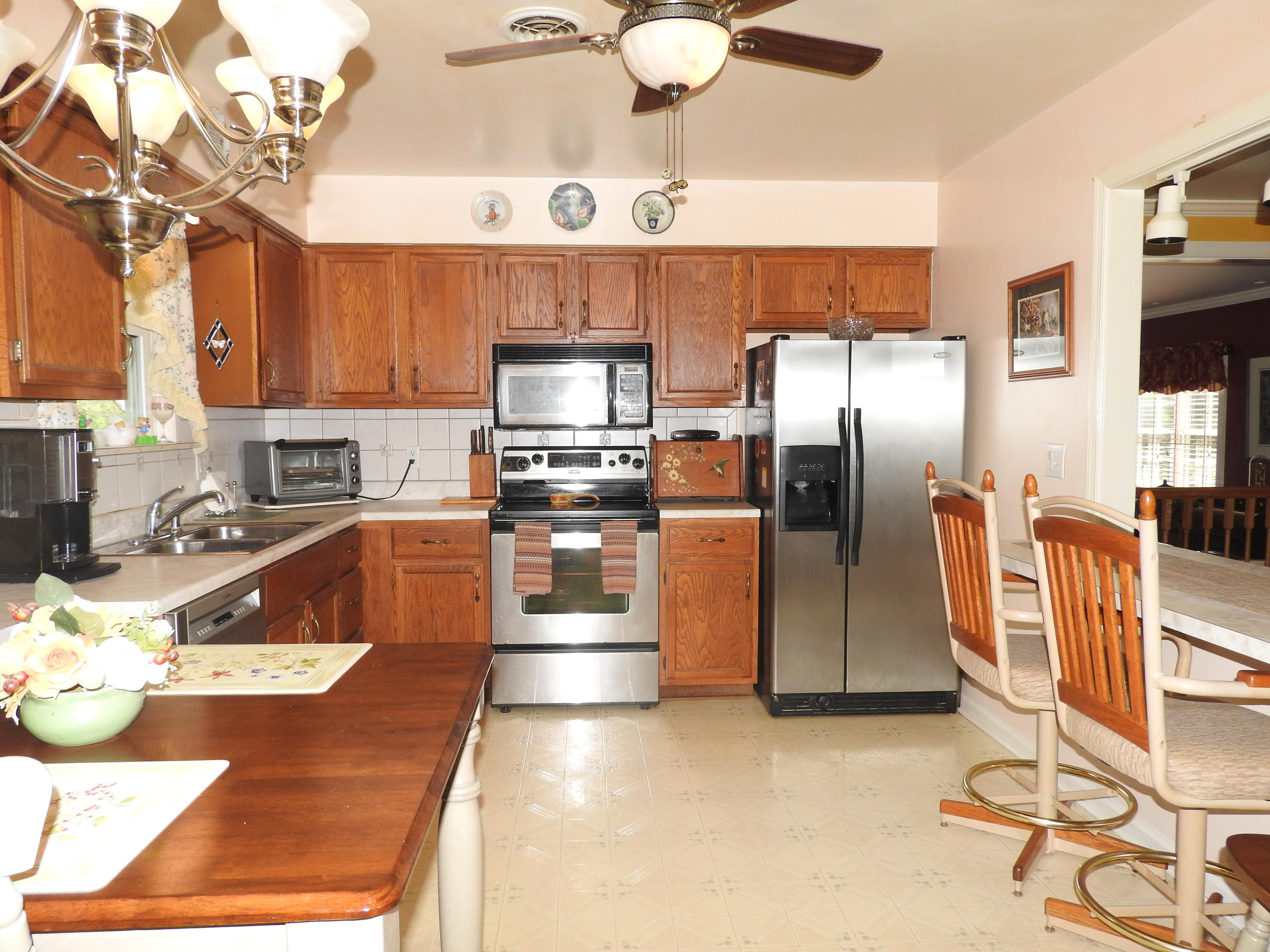2370 Morgans Mill Road Goodview, VA 24095 - Photo 3 of 24 a kitchen with stainless steel appliances granite countertop a sink a stove and a refrigerator