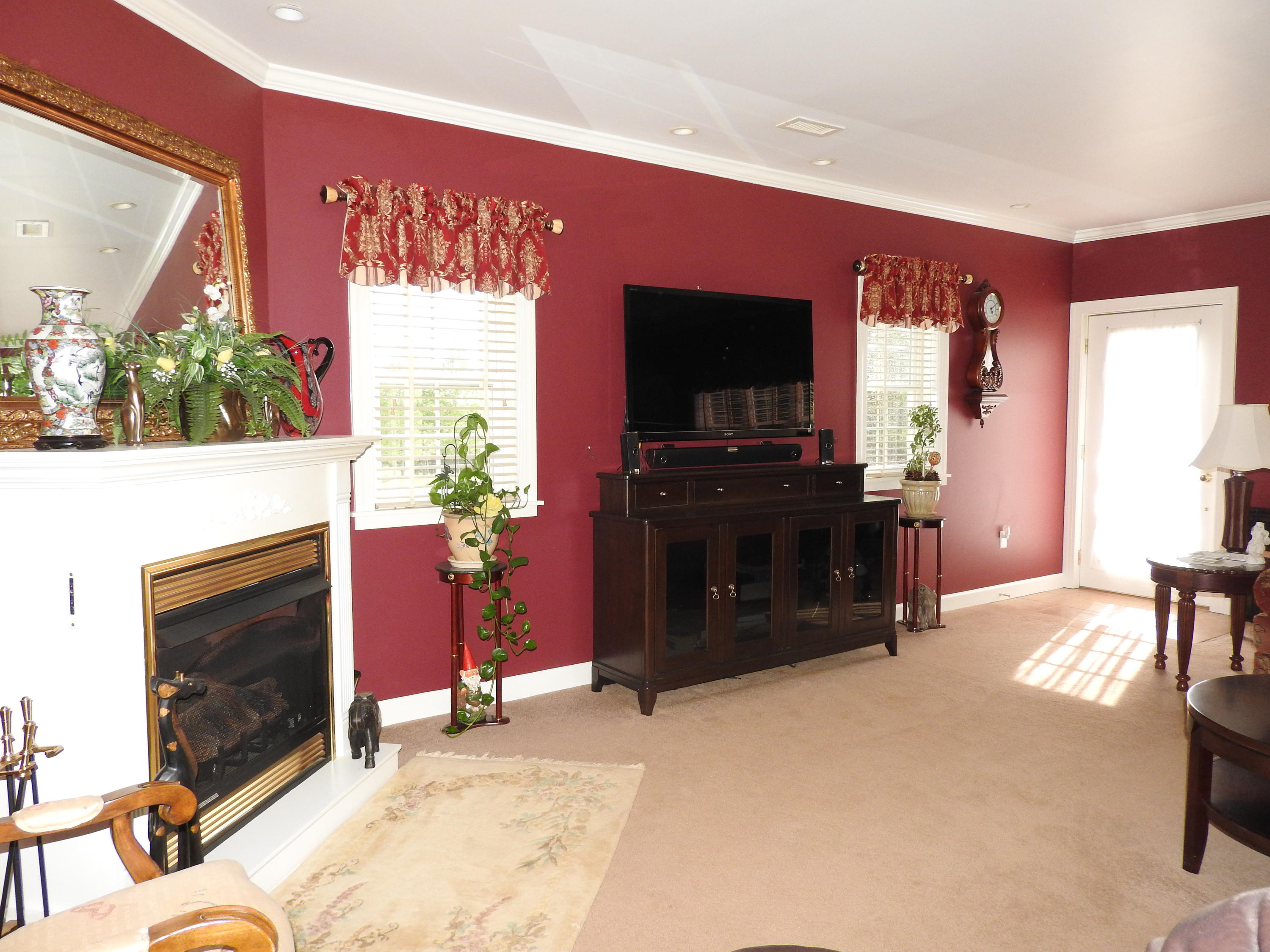 2370 Morgans Mill Road Goodview, VA 24095 - Photo 8 of 24 a living room with furniture a flat screen tv and a fireplace