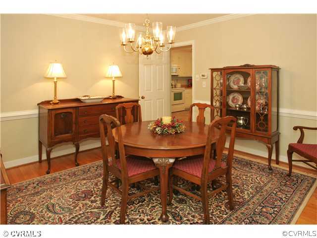 5703 Oak Knoll Road Midlothian, VA 23112 - Photo 4 of 12 a view of a dining room with furniture and wooden floor