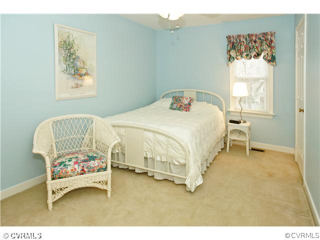 5703 Oak Knoll Road Midlothian, VA 23112 - Photo 9 of 12 a bedroom with a bed and a painting on the wall