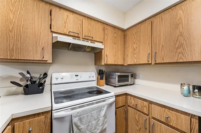 a kitchen with stainless steel appliances granite countertop a sink a stove and a microwave