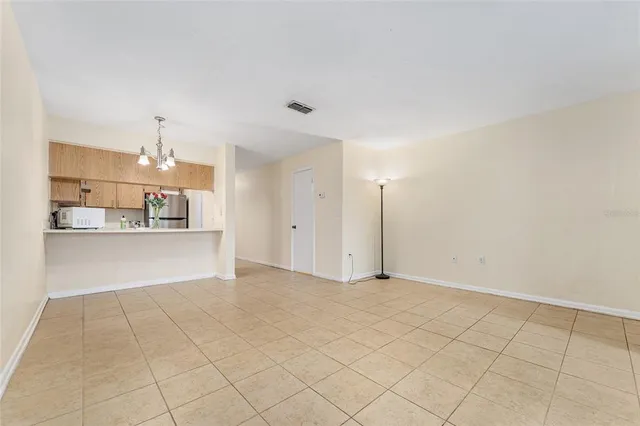 a view of a refrigerator and more cabinets