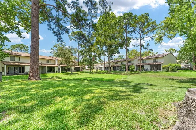 a view of a house with yard and sitting area