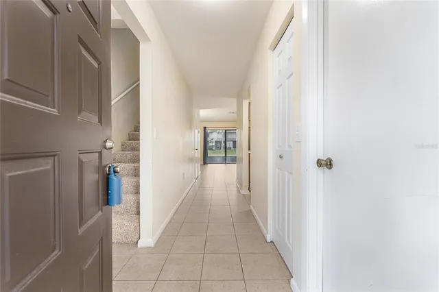 a view of a hallway with wooden shelves