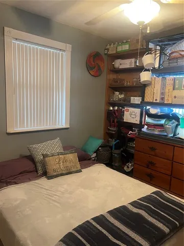 a bedroom with a bed and dresser