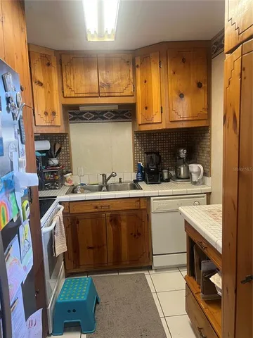 a kitchen with stainless steel appliances granite countertop a sink and cabinets