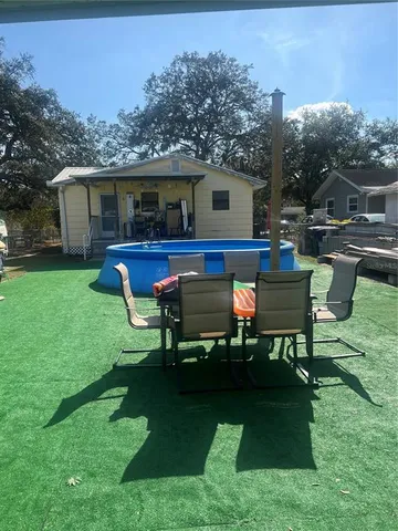 a house view with a sitting space garden view with a table