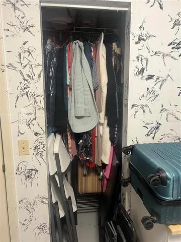 a living room with a mirror and a wooden floor