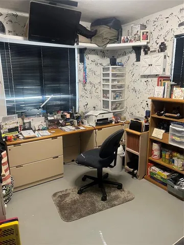 a room with furniture a flat screen tv and a fireplace