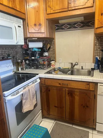 a kitchen with a sink stove and cabinets