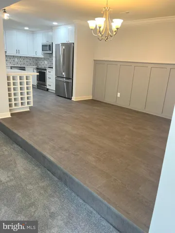 a view of a kitchen with a sink and cabinets