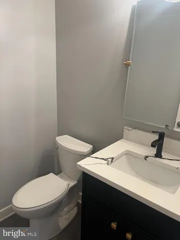 a white toilet sitting next to a bathroom sink
