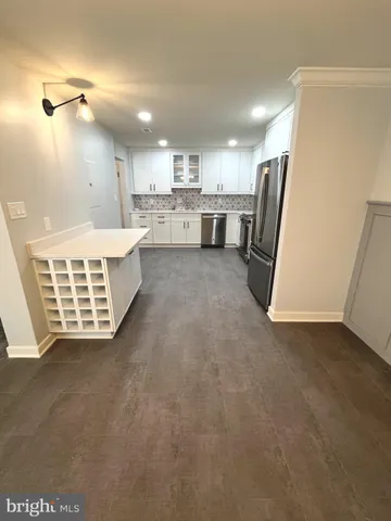a view of kitchen with stainless steel appliances cabinets