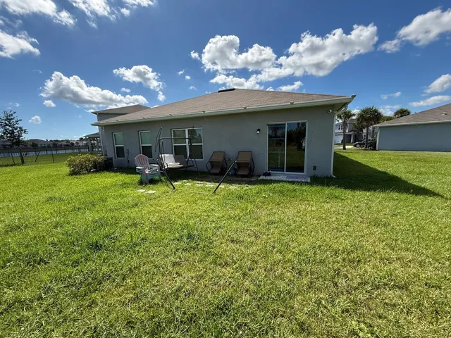 a view of a house with a yard and a patio