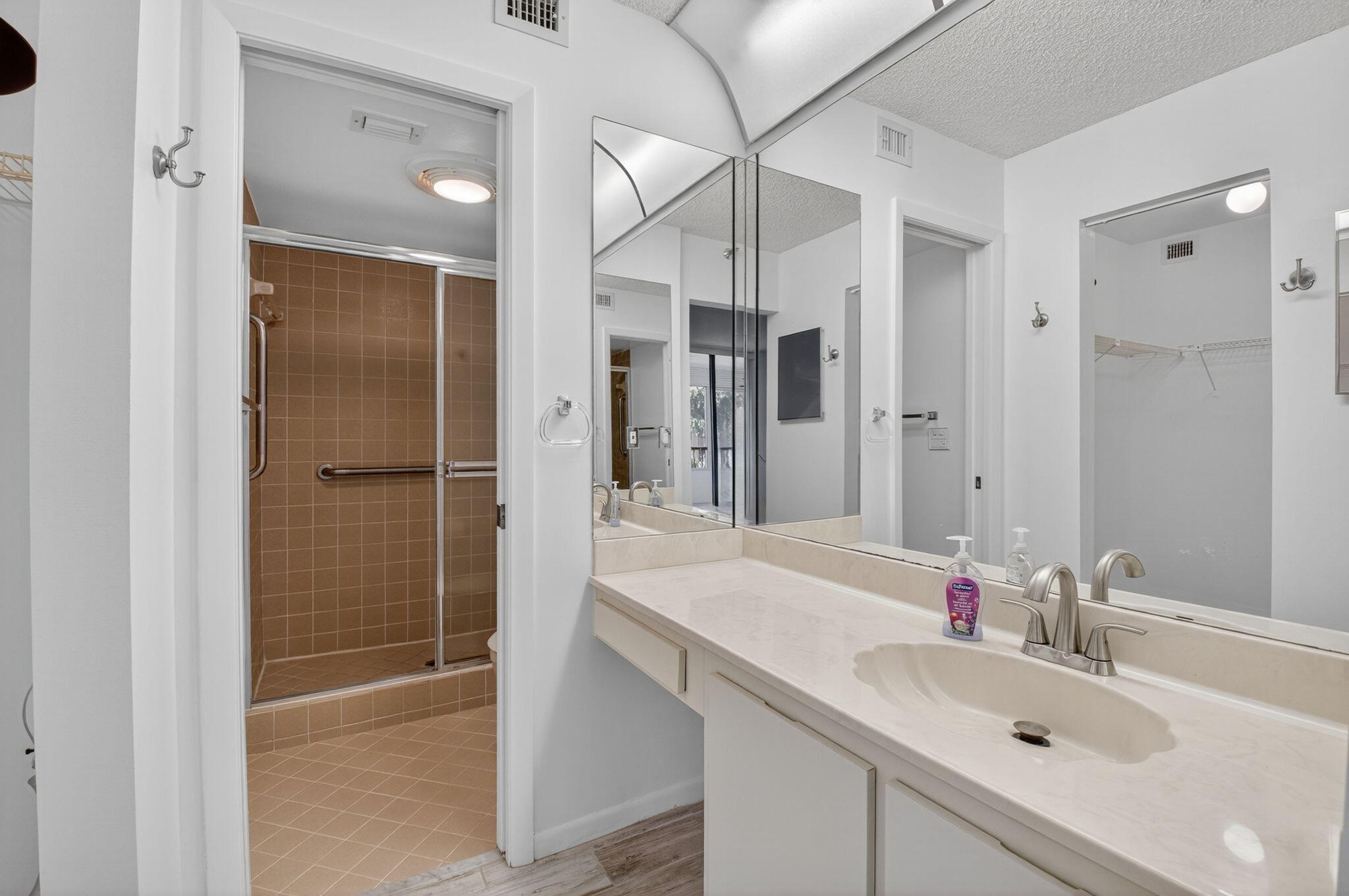 1850 Homewood Boulevard, Unit 214 Delray Beach, FL 33445 - Photo 14 of 38 a bathroom with a sink shower and a mirror