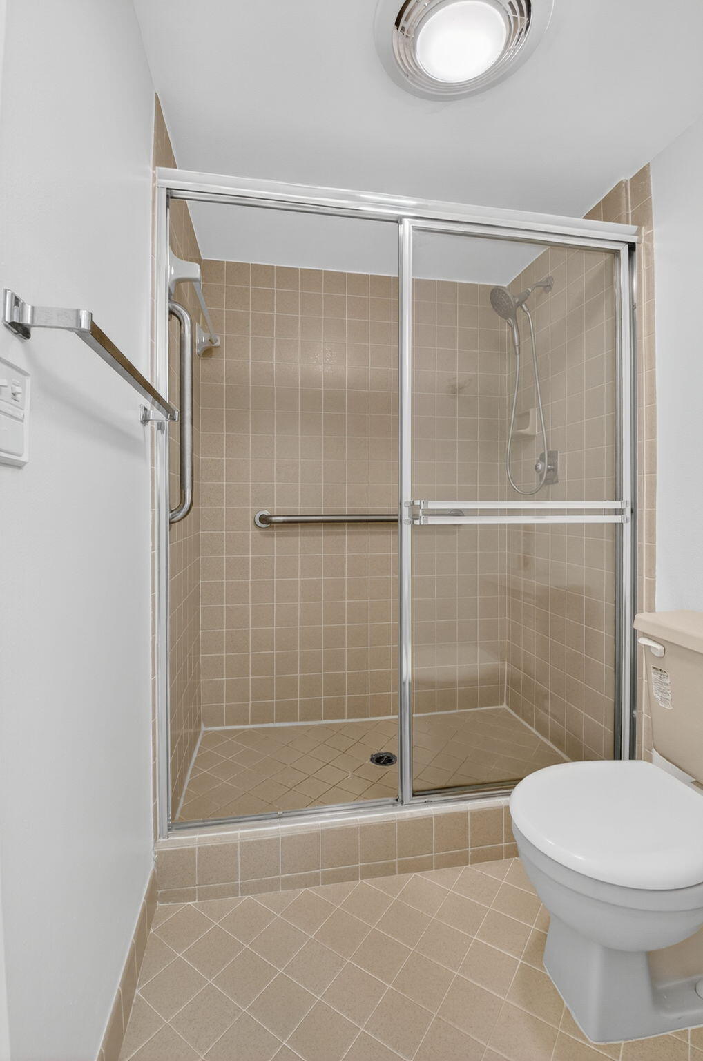1850 Homewood Boulevard, Unit 214 Delray Beach, FL 33445 - Photo 15 of 38 a bathroom with a shower a toilet and a sink
